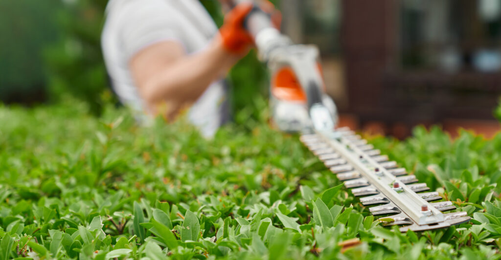 Worker Is Cutting Grass With Hose 1024x532
